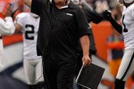 DENVER - OCTOBER 24:  Head coach Tom Cable of the Oakland Raiders signals for an extra point following a touchdown against the Denver Broncos in the first quarter at INVESCO Field at Mile High on October 24, 2010 in Denver, Colorado. The Raiders defeated the Broncos 59-14. (Photo by Justin Edmonds/Getty Images)