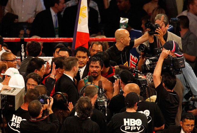 ARLINGTON, TX - NOVEMBER 13:  Manny Pacquiao (white trunks) of the Philippines is interviewed after he won against Antonio Margarito (black trunks) of Mexico during their WBC World Super Welterweight Title bout at Cowboys Stadium on November 13, 2010 in Arlington, Texas.  (Photo by Tom Pennington/Getty Images)