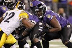 BALTIMORE, MD - DECEMBER 05:  Michael Oher #74 of the Baltimore Ravens blocks James Harrison #92 of the Pittsburgh Steelers at M&T Bank Stadium on December 5, 2010 in Baltimore, Maryland.  (Photo by Geoff Burke/Getty Images)