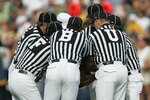 SOUTH BEND, IN - SEPTEMBER 16:  Referees hudle up prior to the start of the game between the Notre Dame Fighting Irish and the Michigan Wolverines September 16, 2006 at Notre Dame Stadium in South Bend, Indiana. Michigan won 47-21.  (Photo by Jonathan Daniel/Getty Images)
