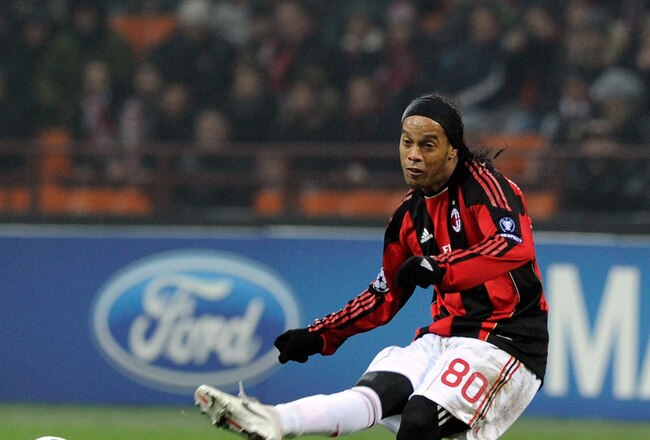 MILAN, ITALY - DECEMBER 08:  Ronaldinho of AC Milan and Demy de Zeeuw (L) of AFC Ajax compete for the ball during the UEFA Champions League Group G match between AC Milan and AFC Ajax at Stadio Giuseppe Meazza on December 8, 2010 in Milan, Italy.  (Photo by Claudio Villa/Getty Images)