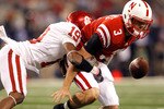 ARLINGTON, TX - DECEMBER 04:  Quarterback Taylor Martinez #3 of the Nebraska Cornhuskers fumbles the ball under pressure from defensive back Demontre Hurst #19 of the Oklahoma Sooners at Cowboys Stadium on December 4, 2010 in Arlington, Texas. The Sooners beat the Cornhuskers 23-20.  (Photo by Tom Pennington/Getty Images)