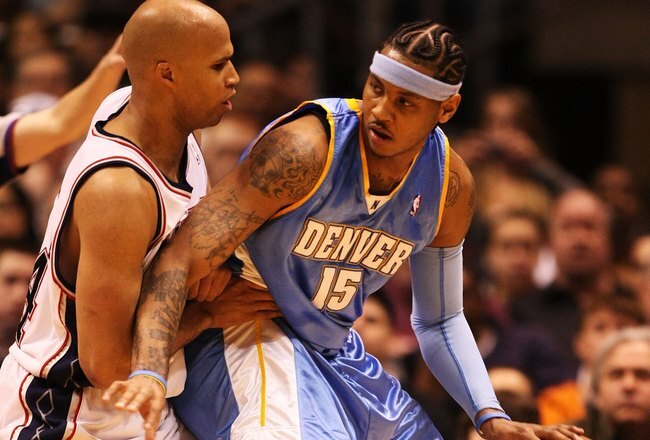 EAST RUTHERFORD, NJ - MARCH 21:  Carmelo Anthony #15 of the Denver Nuggets dribbles against Richard Jefferson #24 of the New Jersey Nets during their game on March 21, 2008 at the Izod Arena in East Rutherford, New Jersey.  Photo By Al Bello/Getty Images.  NOTE TO USER: User expressly acknowledges and agrees that, by downloading and/or using this Photograph, user is consenting to the terms and conditions of the Getty Images License Agreement.  (Photo by Al Bello/Getty Images)