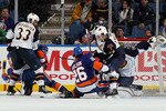 UNIONDALE, NY - DECEMBER 11:  Dustin Byfuglien #33 and Tobias Enstrom #39 of the Atlanta Thrashers defend against John Tavares #91 and Matt Moulson #26 of the New York Islanders on December 11, 2010 at Nassau Coliseum in Uniondale, New York. The Thrashers defeated the Isles 5-4.  (Photo by Jim McIsaac/Getty Images)
