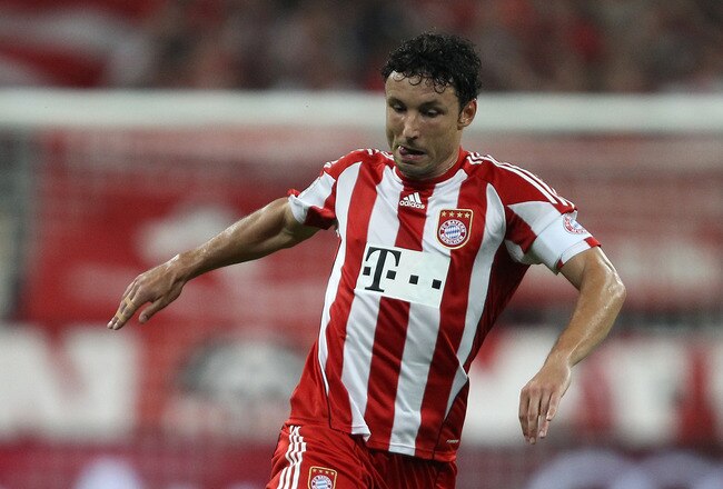MUNICH, GERMANY - AUGUST 20: Mark van Bommel of Bayern is challenged by Cicero of Wolfsburg during the Bundesliga match between FC Bayern Muenchen and VfL Wolfsburg at Allianz Arena on August 20, 2010 in Munich, Germany.  (Photo by Clive Brunskill/Getty Images)