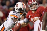 TUSCALOOSA, AL - NOVEMBER 26:  T'Sharvan Bell #22 of the Auburn Tigers sacks quarterback Greg McElroy #12 of the Alabama Crimson Tide at Bryant-Denny Stadium on November 26, 2010 in Tuscaloosa, Alabama.  McElroy was injured on this sack.  (Photo by Kevin C. Cox/Getty Images)