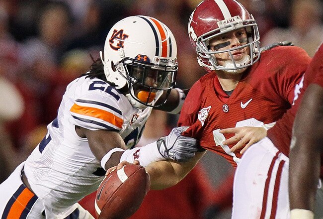 TUSCALOOSA, AL - NOVEMBER 26:  T'Sharvan Bell #22 of the Auburn Tigers sacks quarterback Greg McElroy #12 of the Alabama Crimson Tide at Bryant-Denny Stadium on November 26, 2010 in Tuscaloosa, Alabama.  McElroy was injured on this sack.  (Photo by Kevin C. Cox/Getty Images)