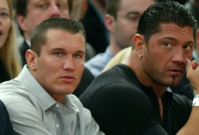 NEW YORK - MARCH 9:  WWE wrestlers (L-R) Triple H, Ric Flair, Randy Orton and Batista sit courtside at the New York Knicks v Boston Celtics  NBA game March 9, 2004 at Madison Square Garden in New York City.   (Photo by Ray Amati/Getty Images)