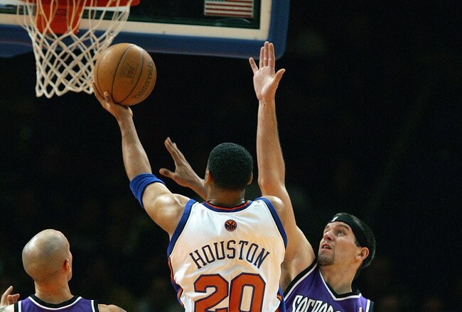 NEW YORK - JANUARY 4:  Allan Houston #20 of the New York Knicks drives to the basket against Brad Miller #52 of the Sacramento Kings on January 4, 2005 at Madison Square Garden in New York City. The Kings won 105-98.  NOTE TO USER: User expressly acknowledges and agrees that, by downloading and or using this photograph, User is consenting to the terms and conditions of the Getty Images License Agreement.  (Photo by Ezra Shaw/Getty Images)