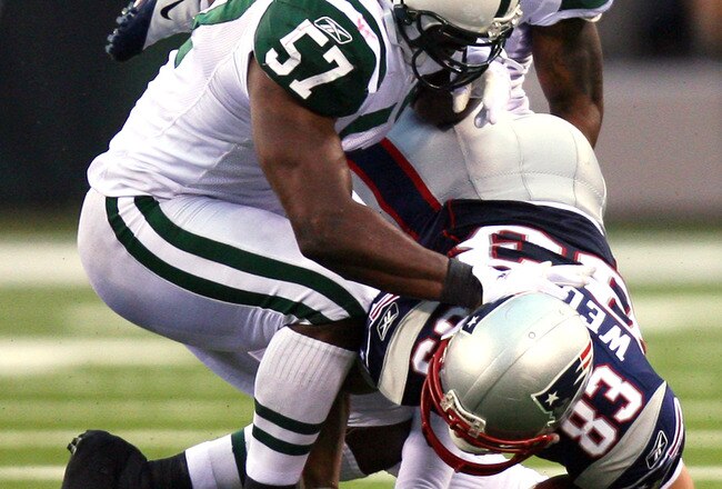 EAST RUTHERFORD, NJ - SEPTEMBER 19:  Wes Welker #83 of the New England Patriots is tackled by Bart Scott #57 of the New York Jets at the New Meadowlands Stadium on September 19, 2010 in East Rutherford, New Jersey. The Jets defeated the Patriots 28 - 14. (Photo by Andrew Burton/Getty Images)