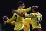LONDON, ENGLAND - JANUARY 15:  Robin van Persie of Arsenal celebrates scoring the opening goal with Theo Walcott during the Barclays Premier League match between West Ham United and Arsenal at the Boleyn Ground on January 15, 2011 in London, England.  (Photo by Clive Rose/Getty Images)