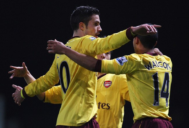 LONDON, ENGLAND - JANUARY 15:  Robin van Persie of Arsenal celebrates scoring the opening goal with Theo Walcott during the Barclays Premier League match between West Ham United and Arsenal at the Boleyn Ground on January 15, 2011 in London, England.  (Photo by Clive Rose/Getty Images)