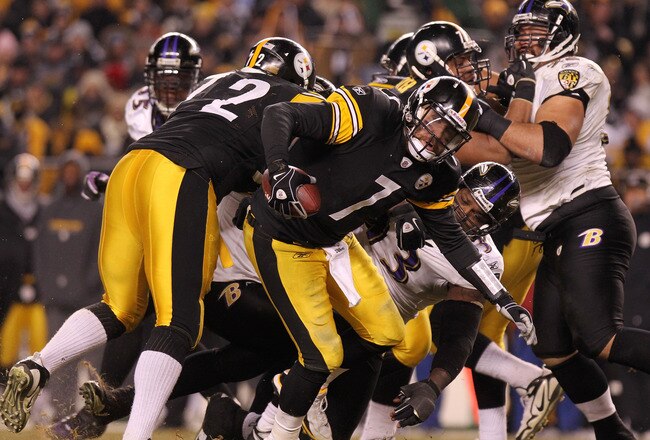 PITTSBURGH, PA - JANUARY 15:  Quarterback Ben Roethlisberger #7 of the Pittsburgh Steelers breaks a tackle by defensive end Cory Redding #93 of the Baltimore Ravens in the AFC Divisional Playoff Game at Heinz Field on January 15, 2011 in Pittsburgh, Pennsylvania.  (Photo by Nick Laham/Getty Images)