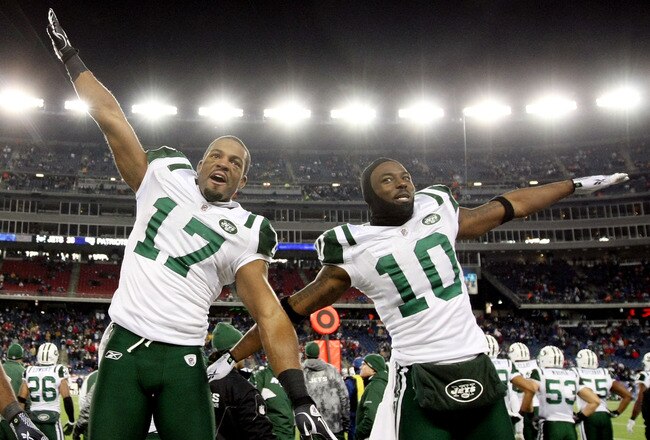 FOXBORO, MA - JANUARY 16:  Braylon Edwards #17 and Santonio Holmes #10 of the New York Jets celebrate on their way to defeating the New England Patriots 28 to 21 victory over the New England Patriots during their 2011 AFC divisional playoff game at Gillette Stadium on January 16, 2011 in Foxboro, Massachusetts.  (Photo by Al Bello/Getty Images)