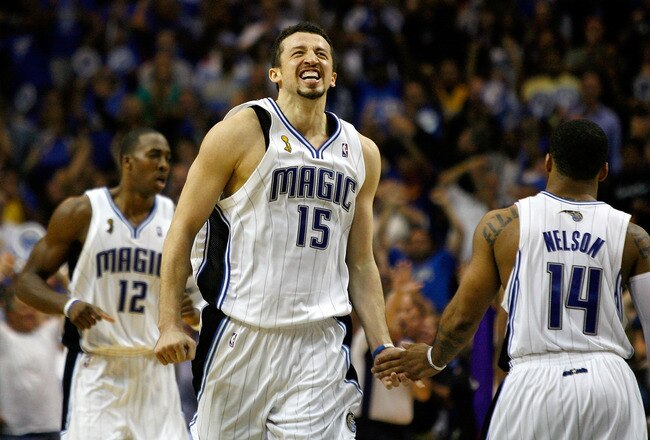 ORLANDO, FL - JUNE 11:  (M) Hedo Turkoglu #15 of the Orlando Magic gives teammate (R) Jameer Nelson #14 a five in the final minute of the fourth quarter in Game Four of the 2009 NBA Finals against the Los Angeles Lakers on June 11, 2009 at Amway Arena in Orlando, Florida.  NOTE TO USER:  User expressly acknowledges and agrees that, by downloading and or using this photograph, User is consenting to the terms and conditions of the Getty Images License Agreement.  (Photo by Chris Graythen/Getty Images)