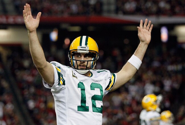 ATLANTA, GA - JANUARY 15:  Aaron Rodgers #12 of the Green Bay Packers reacts after he threw a 7-yard touchdown to John Kuhn #30 in the third quarter against the Atlanta Falcons during their 2011 NFC divisional playoff game at Georgia Dome on January 15, 2011 in Atlanta, Georgia.  (Photo by Kevin C. Cox/Getty Images)
