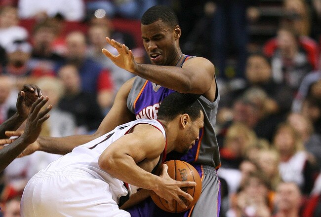 PORTLAND, OR - APRIL 29:  Brandon Roy #7 of the Portland Trail Blazers is swarmed by Jason Richardson #23 (L) and Jarron Collins #20 of the Phoenix Suns during Game Six of the Western Conference Quarterfinals of the NBA Playoffs on April 29, 2010 at the Rose Garden in Portland, Oregon. The Suns defeated the Blazers  99-90. NOTE TO USER: User expressly acknowledges and agrees that, by downloading and or using this Photograph, user is consenting to the terms and conditions of the Getty Images License Agreement. (Photo by Otto Greule Jr/Getty Images)