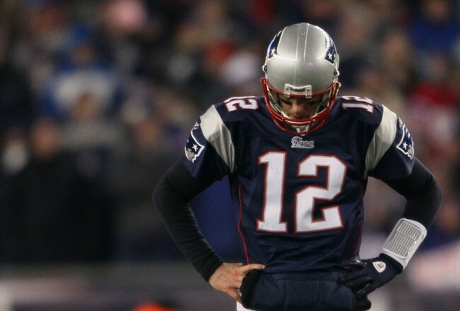FOXBORO, MA - JANUARY 16:  Tom Brady #12 of the New England Patriots looks on near the end of their 28 to 21 loss to the New York Jets in their 2011 AFC divisional playoff game at Gillette Stadium on January 16, 2011 in Foxboro, Massachusetts.  (Photo by Elsa/Getty Images)