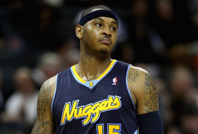 CHARLOTTE, NC - DECEMBER 07:  Carmelo Anthony #15 of the Denver Nuggets watches on against the Charlotte Bobcats during their game at Time Warner Cable Arena on December 7, 2010 in Charlotte, North Carolina.  NOTE TO USER: User expressly acknowledges and agrees that, by downloading and/or using this Photograph, User is consenting to the terms and conditions of the Getty Images License Agreement.  (Photo by Streeter Lecka/Getty Images)