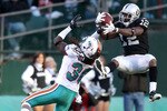 OAKLAND, CA - NOVEMBER 28:  Jacoby Ford #12 of the Oakland Raiders catches the ball while defended by Chris Clemons #30 of the Miami Dolphins at Oakland-Alameda County Coliseum on November 28, 2010 in Oakland, California.  (Photo by Ezra Shaw/Getty Images)
