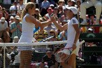 LONDON, ENGLAND - JUNE 28:  Kim Clijsters of Belgium shakes hands after winning her match against Justine Henin of Belgium on Day Seven of the Wimbledon Lawn Tennis Championships at the All England Lawn Tennis and Croquet Club on June 28, 2010 in London, England.  (Photo by Hamish Blair/Getty Images)