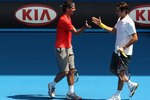 MELBOURNE, AUSTRALIA - JANUARY 16:  Rafael Nadal of Spain and Roger Federer of Switzerland celebrate a point during the 'Rally For Relief' charity exhibition match ahead of the 2011 Australian Open at Melbourne Park on January 16, 2011 in Melbourne, Australia.  (Photo by Mark Dadswell/Getty Images)