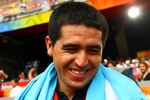 BEIJING - AUGUST 23: Argentinian Juan Roman Riquelme his national flag during the men's Olympic football tournament medal ceremony at the Men's Final between Nigeria and Argentina at the National Stadium on Day 15 of the Beijing 2008 Olympic Games on August 23, 2008 in Beijing, China. (Photo by Koji Watanabe/Getty Images)