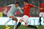 ROME, ITALY - JANUARY 19:  Alvaro Gonzalez of SS Lazio (L) in action against Leandro Greco of AS Roma during the TIM Cup match between AS Roma and SS Lazio at Stadio Olimpico on January 19, 2011 in Rome, Italy.  (Photo by Paolo Bruno/Getty Images)