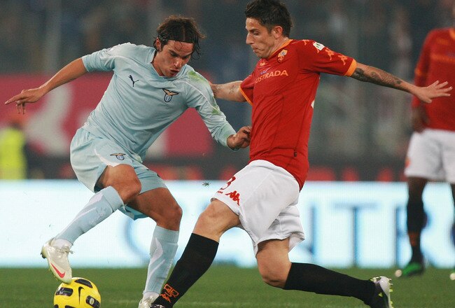 ROME, ITALY - JANUARY 19:  Alvaro Gonzalez of SS Lazio (L) in action against Leandro Greco of AS Roma during the TIM Cup match between AS Roma and SS Lazio at Stadio Olimpico on January 19, 2011 in Rome, Italy.  (Photo by Paolo Bruno/Getty Images)
