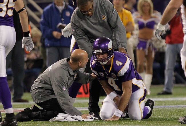 MINNEAPOLIS, MN - DECEMBER 05:  Brett Favre #4 of the Minnesota Vikings is assisted by medical staff against the Buffalo Bills defense at the Mall of America Field at the Hubert H. Humphrey Metrodome on December 5, 2010 in Minneapolis, Minnesota.  (Photo by Nick Laham/Getty Images)