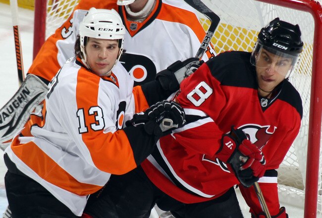 NEWARK, NJ - JANUARY 06: Daniel Carcillo #13 of the Philadelphia Flyers move Dainius Zubrus #8 of the New Jersey Devils out of the crease at the Prudential Center on January 6, 2011 in Newark, New Jersey.  (Photo by Bruce Bennett/Getty Images)