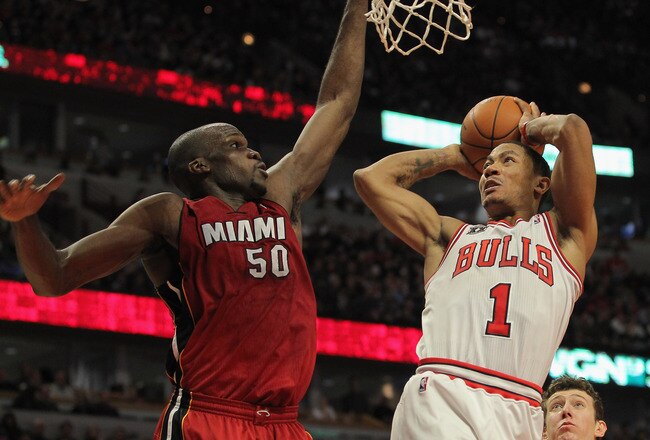 CHICAGO, IL - JANUARY 15:  Derrick Rose #1 of the Chicago Bulls gets off a shot as he is fouled by Joel Anthony #50 of the Miami Heat while Chris Bosh #1 of the Heat follows the action at the United Center on January 15, 2011 in Chicago, Illinois. NOTE TO USER: User expressly acknowledges and agrees that, by downloading and or using this photograph, User is consenting to the terms and conditions of the Getty Images License Agreement.  (Photo by Doug Pensinger/Getty Images)