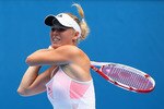 MELBOURNE, AUSTRALIA - JANUARY 19:  Caroline Wozniacki of Denmark plays a backhand in her second round match against Vania King of the United States of America during day three of the 2011 Australian Open at Melbourne Park on January 19, 2011 in Melbourne, Australia.  (Photo by Cameron Spencer/Getty Images)