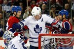 MONTREAL - NOVEMBER 20:  Mike Komisarek #8 of the Toronto Maple Leafs clears Travis Moen #32 and Scott Gomez #11 of the Montreal Canadiens from the net during the NHL game at the Bell Centre on November 20, 2010 in Montreal, Quebec, Canada.  The Canadiens defeated the Maple Leafs 2-0.  (Photo by Richard Wolowicz/Getty Images)