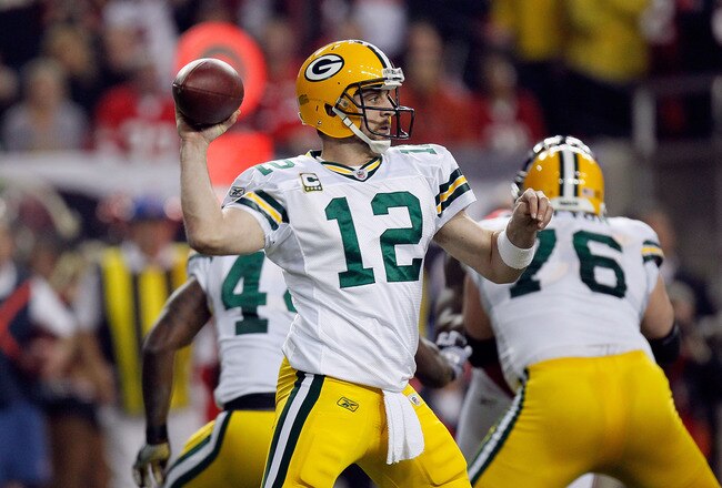ATLANTA, GA - JANUARY 15:  Quarterback Aaron Rodgers #12  of the Green Bay Packers throws a pass against the Atlanta Falcons during their 2011 NFC divisional playoff game at Georgia Dome on January 15, 2011 in Atlanta, Georgia.  (Photo by Kevin C. Cox/Getty Images)
