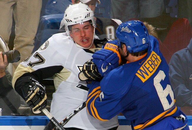 BUFFALO, NY - DECEMBER 11: Mike Weber #6 of the Buffalo Sabres checks Sidney Crosby #87 of the Pittsburgh Penguins at HSBC Arena on December 11, 2010 in Buffalo, New York.  (Photo by Rick Stewart/Getty Images)