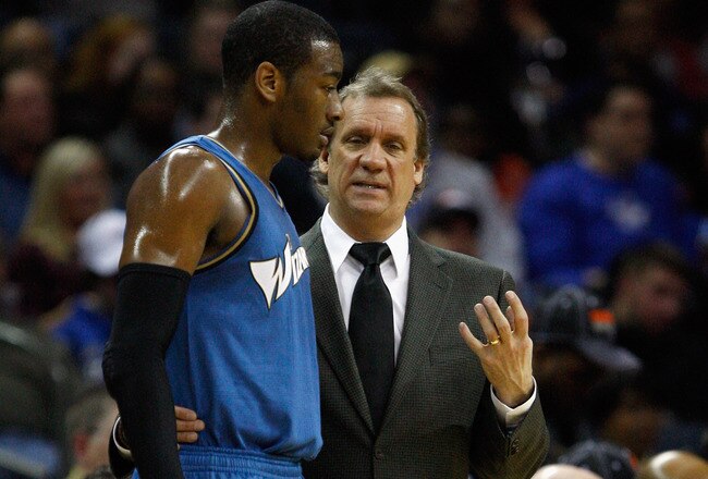 CHARLOTTE, NC - JANUARY 08:  Head coach Flip Saunders and John Wall #2 of the Washington Wizards talk on the sidelines during their game agains the Charlotte Bobcats at Time Warner Cable Arena on January 8, 2011 in Charlotte, North Carolina. NOTE TO USER: User expressly acknowledges and agrees that, by downloading and/or using this Photograph, User is consenting to the terms and conditions of the Getty Images License Agreement.  (Photo by Streeter Lecka/Getty Images)