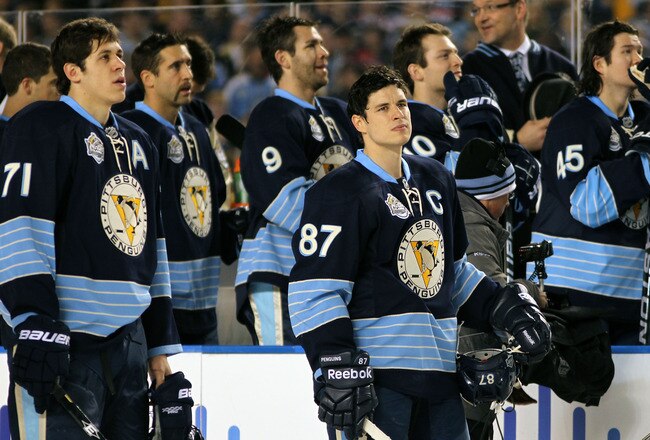 PITTSBURGH, PA - JANUARY 01:  Evgeni Malkin #71, Sidney Crosby #87 and Brooks Orpik #44 of the Pittsburgh Penguins look on during opening ceremonies before the start of the 2011 NHL Bridgestone Winter Classic against the Washington Capitals at Heinz Field on January 1, 2011 in Pittsburgh, Pennsylvania. Washington won 3-1. (Photo by Jamie Squire/Getty Images)
