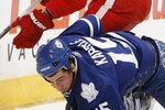TORONTO - OCTOBER 2: Tomas Kaberle #15 of the Toronto Maple Leafs gets knocked down by Justin Abdelkader #8 of the Detroit Red Wings during a preseason NHL game at the Air Canada Centre October 2, 2010 in Toronto, Ontario, Canada. (Photo by Abelimages/Getty Images)