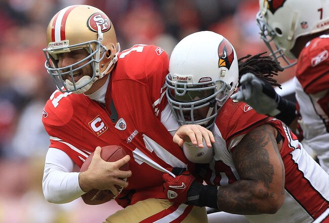 SAN FRANCISCO, CA - JANUARY 02:    Alex Smith #11 of the San Francisco 49ers is sacked by Darnell Dockett #90 of the Arizona Cardinals during an NFL game at Candlestick Park on January 2, 2011 in San Francisco, California.  (Photo by Jed Jacobsohn/Getty Images)