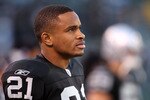 OAKLAND, CA - NOVEMBER 28:  Nnamdi Asomugha #21 of the Oakland Raiders stands on the sidelines during the closing minutes of their loss to the Miami Dolphins at Oakland-Alameda County Coliseum on November 28, 2010 in Oakland, California.  (Photo by Ezra Shaw/Getty Images)