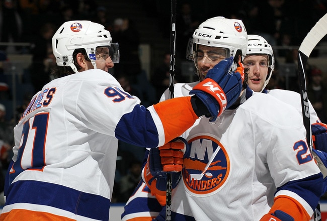 UNIONDALE, NY - JANUARY 23: John Tavares #91 of the New York Islanders congratulates Matt Moulson #26 on his goal at 1:15 of the second period against the Buffalo Sabres at the Nassau Coliseum on January 23, 2011 in Uniondale, New York. (Photo by Bruce Bennett/Getty Images)