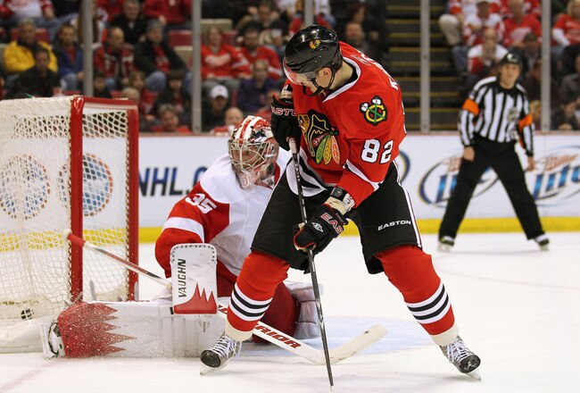 DETROIT, MI - JANUARY 22:  Tomas Kopecky #82 of the Chicago Black Hawks tips a puck past Jimmy Howard #35 of the Detroit Red Wings in a game on January 22, 2011 at the Joe Louis Arena in Detroit, Michigan. The Hawks defeated the Wings 4-1. (Photo by Claus Andersen/Getty Images)