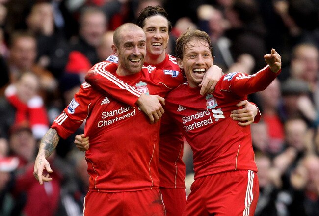 LIVERPOOL, ENGLAND - JANUARY 16:  Raul Meireles of Liverpool (L) celebrates scoring the opening goal with team mates Lucas (R) and Fernando Torres during the Barclays Premier League match between Liverpool and Everton at Anfield on January 16, 2011 in Liverpool, England. (Photo by Alex Livesey /Getty Images)