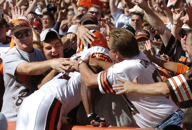 CLEVELAND - AUGUST 21:  Running back Lee Suggs #44 of the Cleveland Browns is welcomed into the Dawg Pound after scoring a touchdown during the second quarter of the pre-season game between the Cleveland Browns and the Detroit Lions on August 21, 2004 at Cleveland Browns Stadium in Cleveland, Ohio. Cleveland defeated Detroit 17-10.  (Photo by David Maxwell/Getty Images)