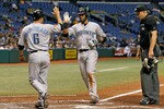ST. PETERSBURG - AUGUST 31:  Infielder Jose Bautista #19 of the Toronto Blue Jays is congratulated by John McDonald #6 after his home run against the Tampa Bay Rays during the game at Tropicana Field on August 31, 2010 in St. Petersburg, Florida.  (Photo by J. Meric/Getty Images)