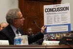 WASHINGTON - SEPTEMBER 23:  Stanley Herring, chairman of the Subcommittee on Education and Advocacy, Head, Neck and Spine Committee of the NFL and team physician for the Seattle Seahawks and Seattle Mariners, holds up a Centers for Disease Control poster about concussions while testifying before the House Education and Labor Committee about the Protecting Student Athletes from Concussions Act on Capitol Hill September 23, 2010 in Washington, DC. Herring testified about the NFL's work to reduce, identify and treat concussions and subconcussive injuries.  (Photo by Chip Somodevilla/Getty Images)