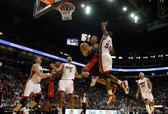 MIAMI, FL - JANUARY 22:  Jerryd Bayless #5 of the Toronto Raptors goes up for a shot against Joel Anthony #50 of the Miami Heat during a game at American Airlines Arena on January 22, 2011 in Miami, Florida. NOTE TO USER: User expressly acknowledges and agrees that, by downloading and/or using this Photograph, User is consenting to the terms and conditions of the Getty Images License Agreement.  (Photo by Mike Ehrmann/Getty Images)