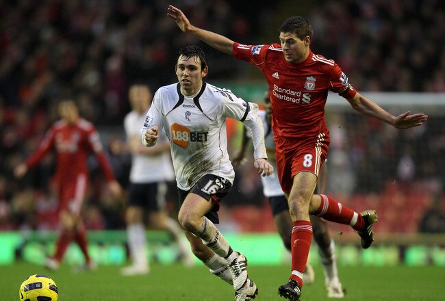 LIVERPOOL, ENGLAND - JANUARY 01:  Steven Gerrard of Liverpool competes for the ball with Mark Davies of Bolton Wanderers during the Barclays Premier League match between Liverpool and Bolton Wanderers at Anfield on January 1, 2011 in Liverpool, England.  (Photo by Michael Steele/Getty Images)