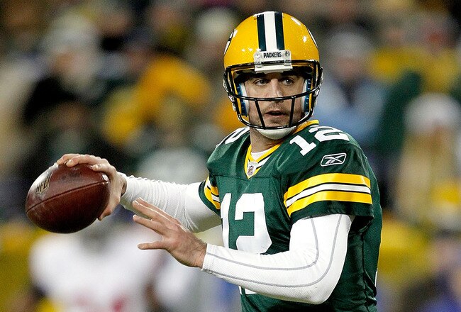 GREEN BAY, WI - DECEMBER 26:  Aaron Rodgers #12 of the Green Bay Packers rolls out of the pocket against the New York Giants at Lambeau Field on December 26, 2010 in Green Bay, Wisconsin.  (Photo by Matthew Stockman/Getty Images)